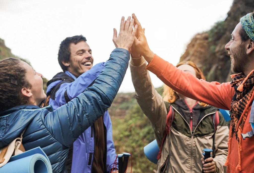 group-of-happy-trekkers-stacking-hands-outdoor-main-focus-on-hands.jpg